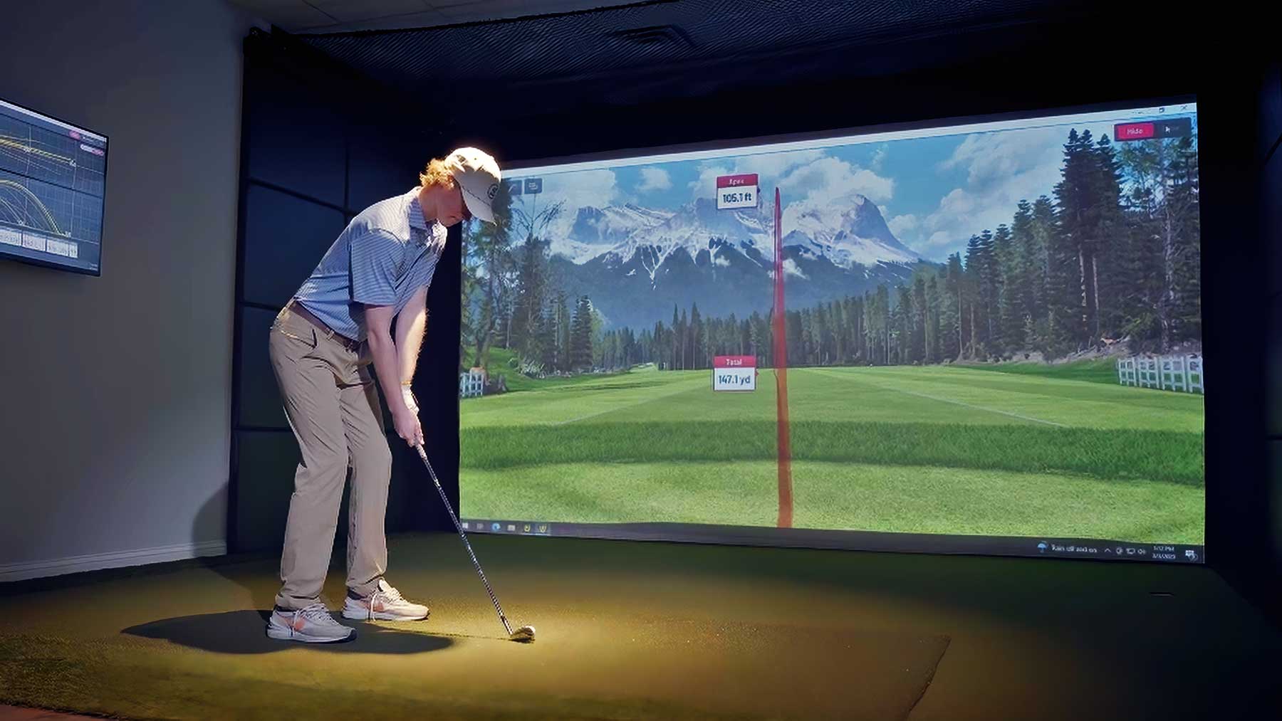 junior golfer lining up iron shot in simulator